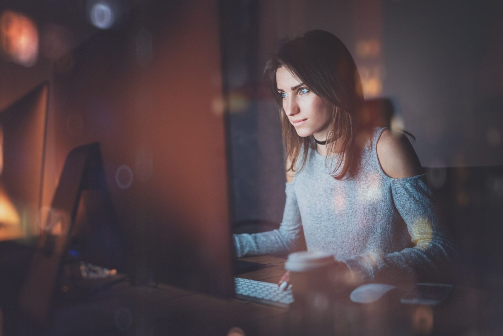 A woman looking at a computer screen