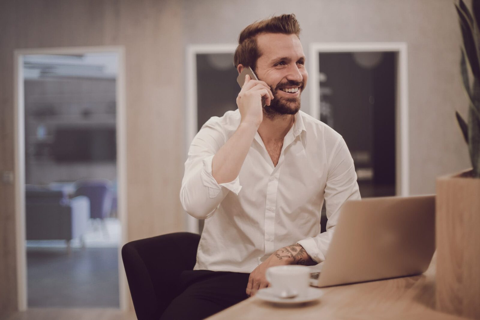 Freelancing - a man talking on the phone sitting at his desk