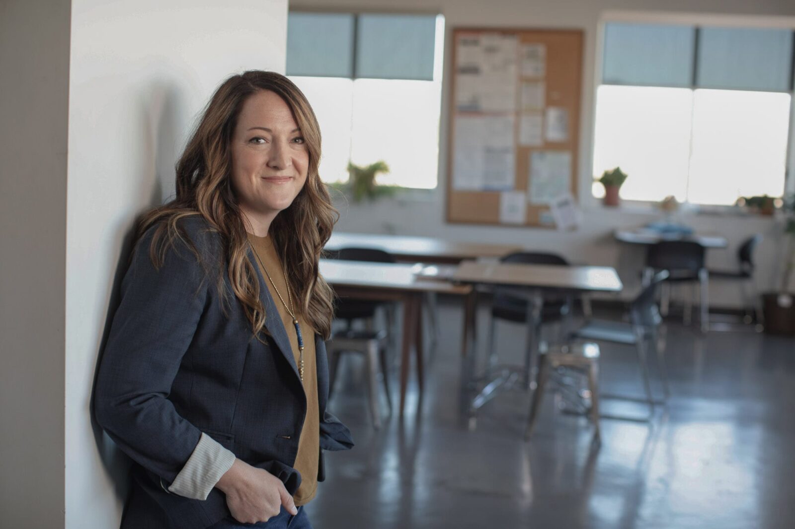 Job Security - Woman leaning against the wall in an office