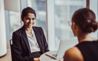 Two women sitting at a table and talking